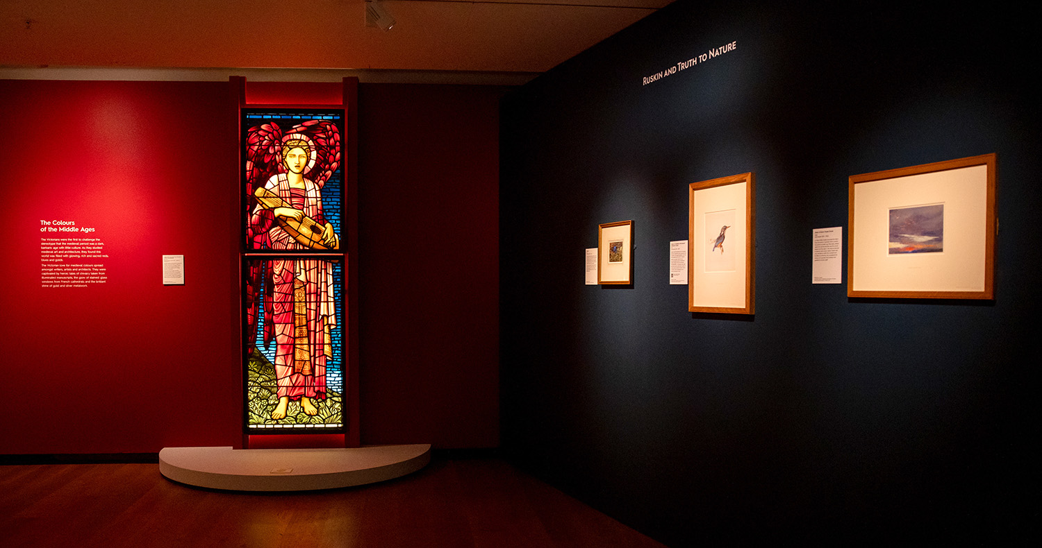 Dark red stained glass display with smaller artworks in the gallery in the Colour Revolution exhibition