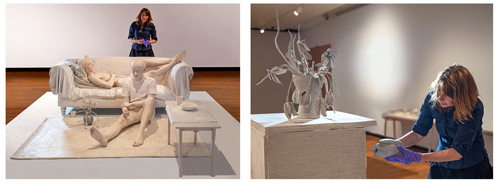 Artist Daphne Wright putting finishes touches to her large clay sculptures in her exhibition
