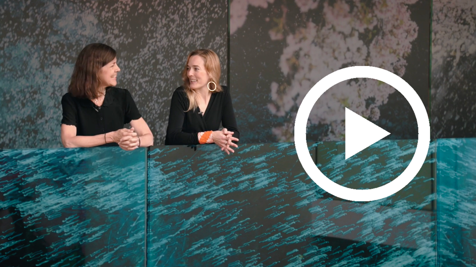 Clare Pollard and Lena Fritsch stand on the bridge at the entrance of the Tokyo exhibition