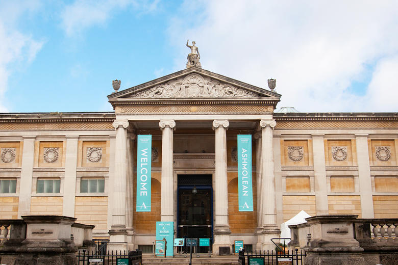 The front of the Museum against a blue and cloudy sky