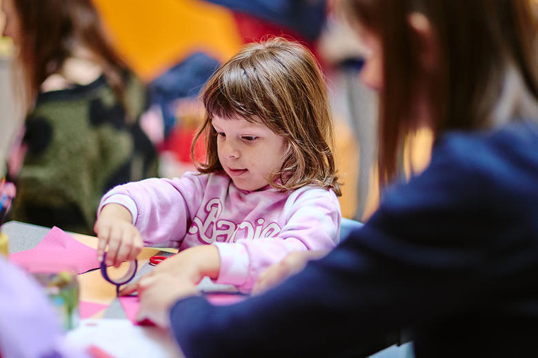 Girl and mother doing craft activities at the family workshop