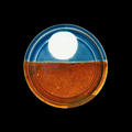 A round plate, the lower half orange, and the upper half blue with a large white circle in the centre