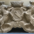 A stone table leg decorated with two horses on hind legs