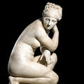 White marble statue of a crouching Venus 