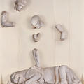 Cast of fragments from the Temple of Zeus showing a lion under parts of a young man's body