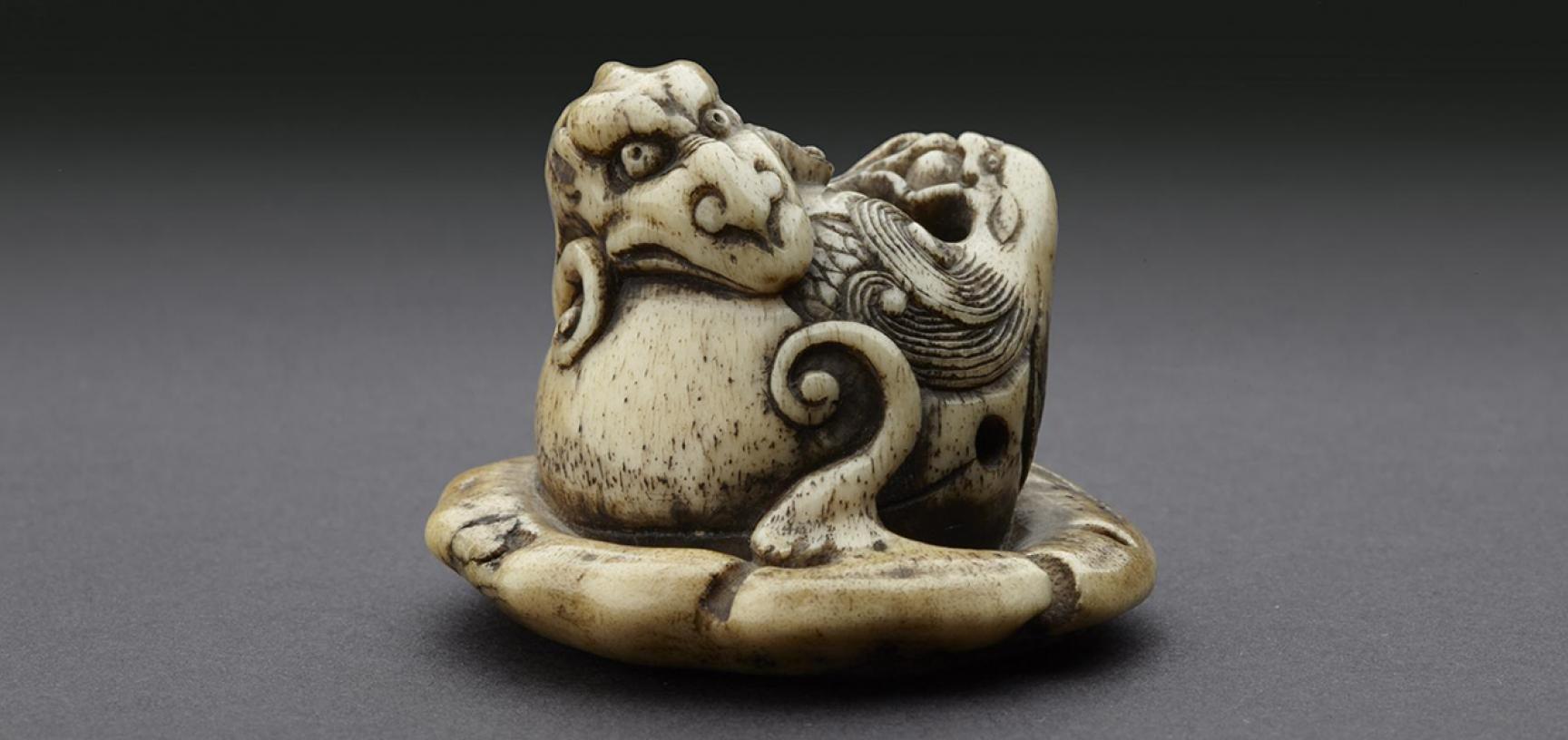 Netsuke in the form of a rain dragon coiled around a mokugyō, a Buddhist percussion instrument from the Ashmolean collections
