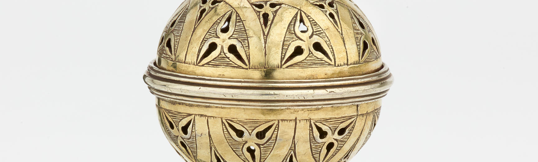 A gold spherical pomander to hold various scents