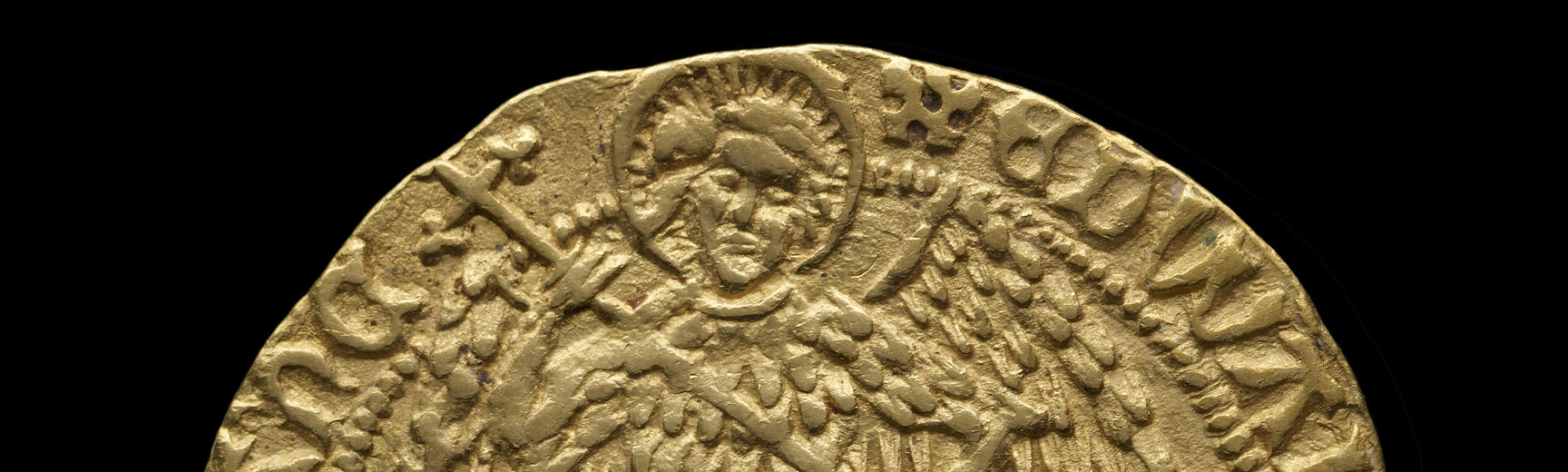 Detail of a gold coin showing a winged Archangel Michael
