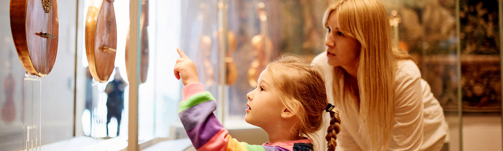 Mother and daughter looking at clocks in the galleries