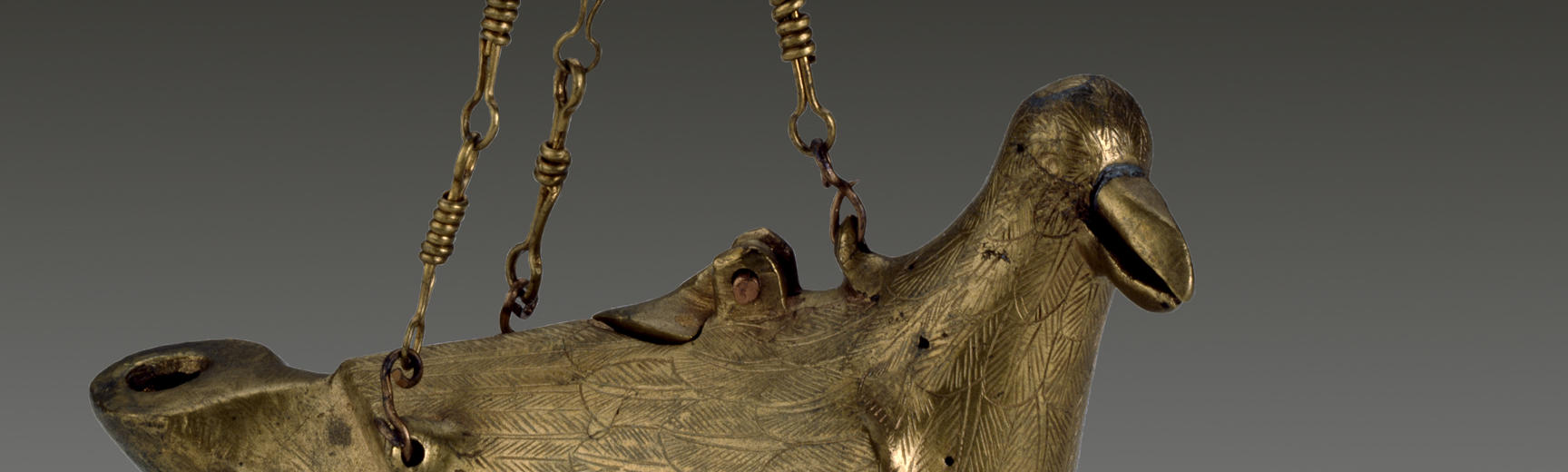 A gold hanging lamp in the form of a dove