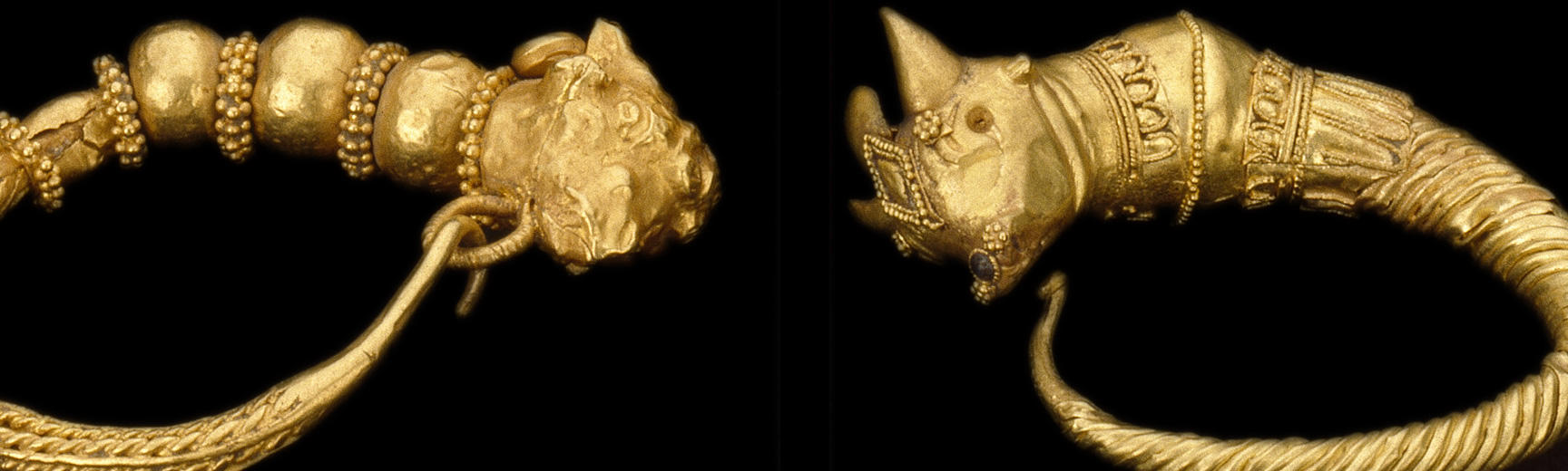 Close up detail of ornate gold earring hoops, with animal head designs