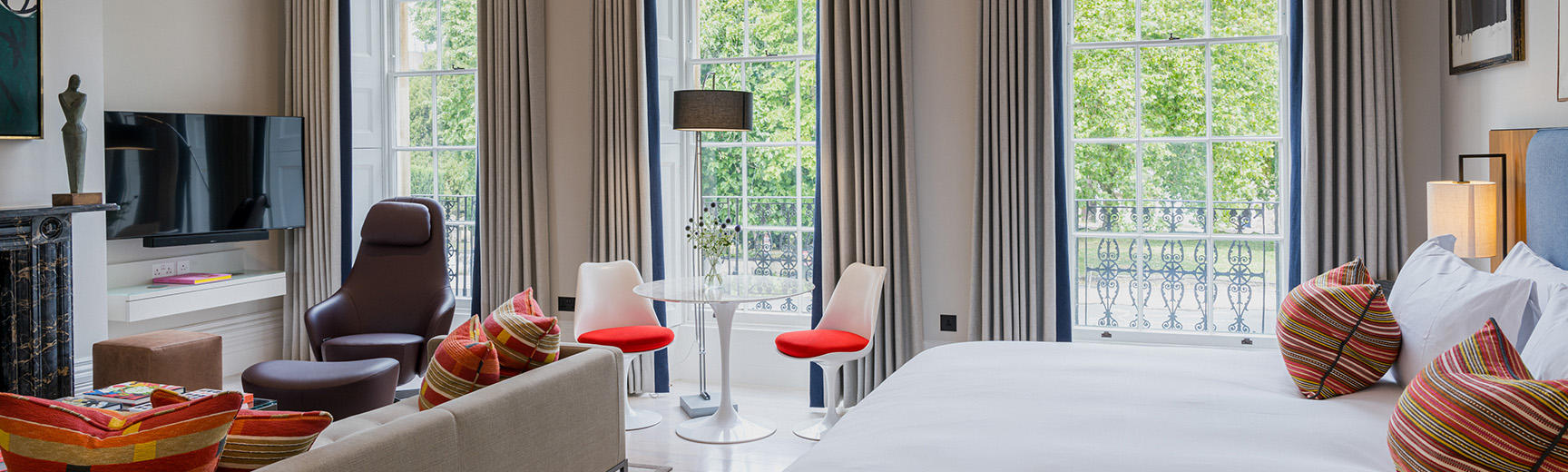 A wide photograph of a luxurious hotel room