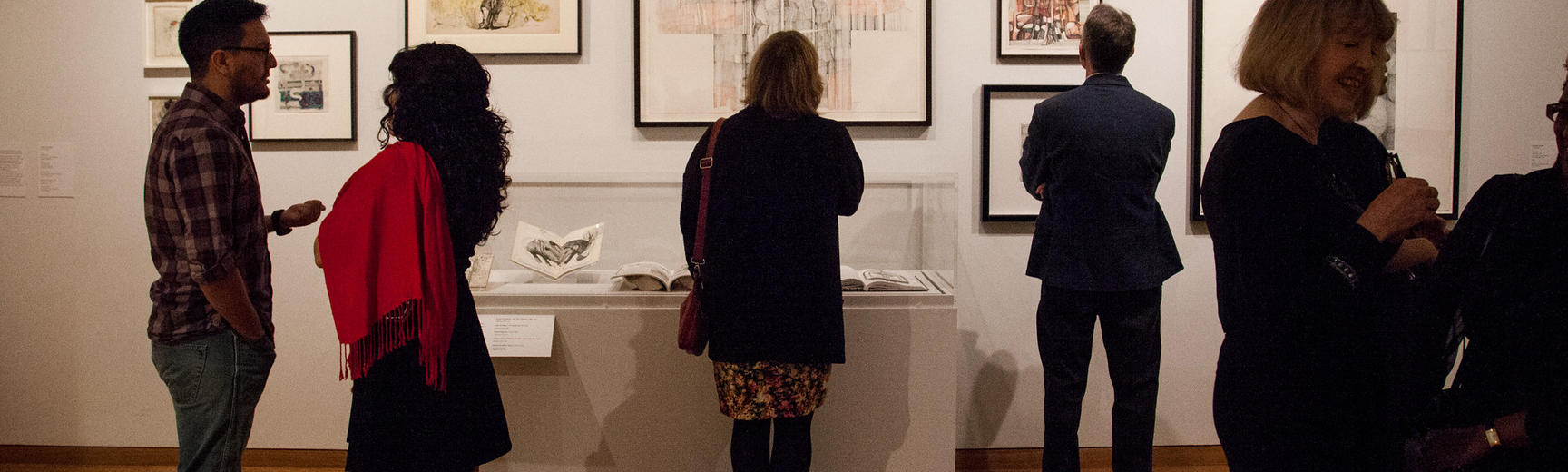 An image of a visitors looking at artwork in a museum gallery