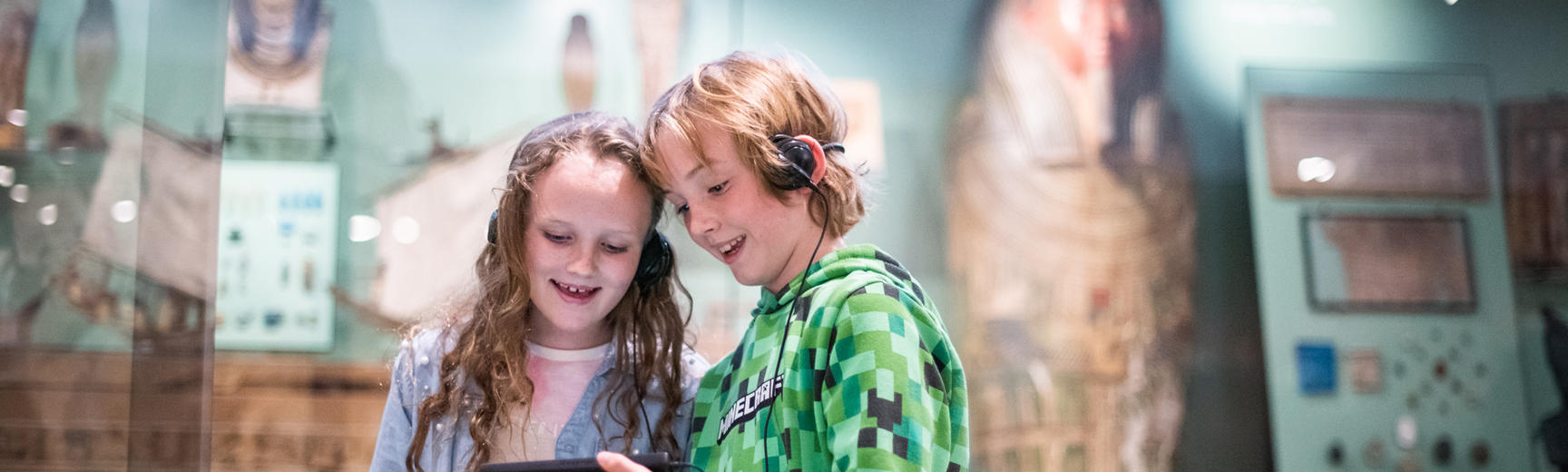Two children in the Egypt gallery holding multimedia guides