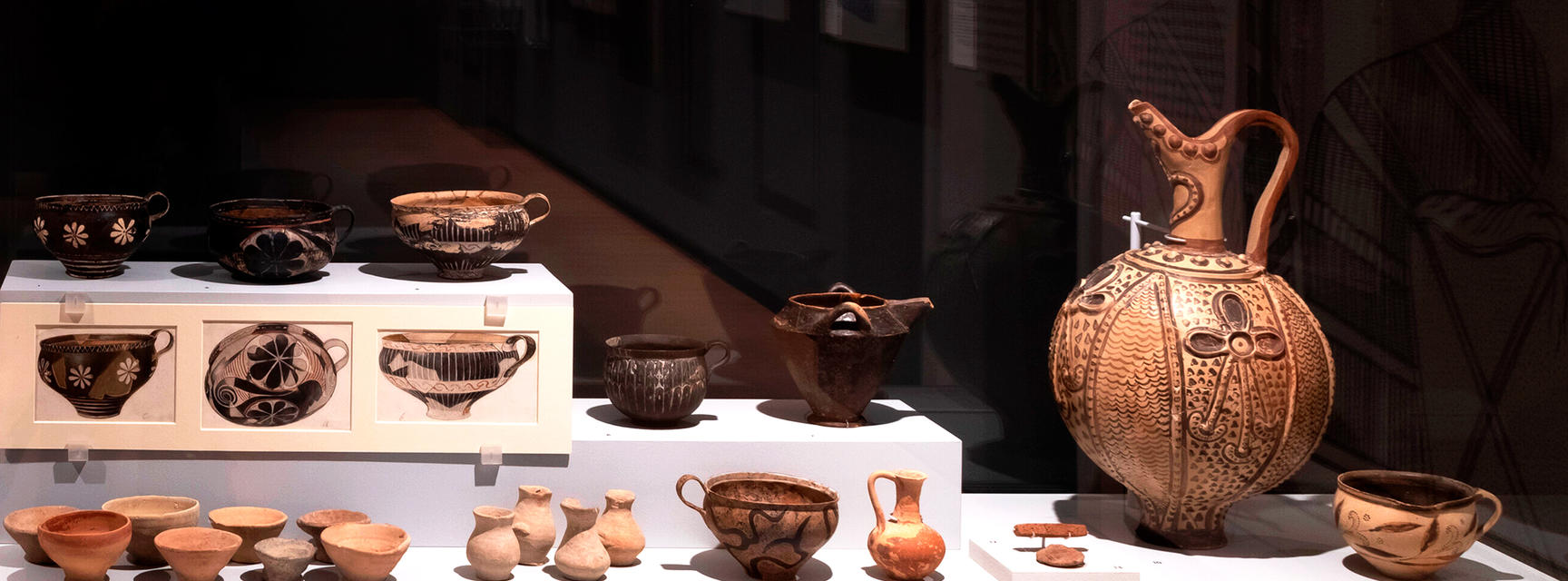 Dining display of ancient Minoan cups, bowls and jugs in the Labyrinth Knossos exhibition