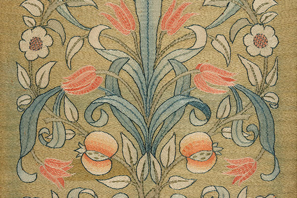 Tulip and pomegranate fire screen or cushion cover, 1890s, polychrome silks on Manchester cloth in subtle yellows, oranges, greens and gold