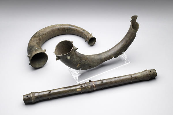 Pre-historic metal instruments, including a flute and horns