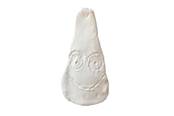 Light coloured stone or clay carving of an Eye idol called Mr Smiley Boy