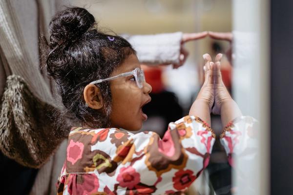 Girl exploring an exhibit at a family event