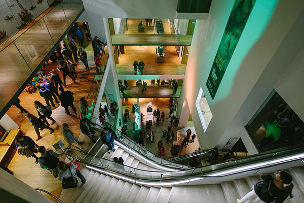 View from above of the museum atrium full of people at an evening event