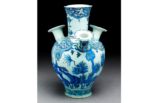 Iranian 'tulip' vase or water pipe with figure, birds, and trees, 17th-century. About 27cm high and painting in blue and black