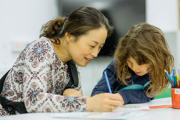 An image of a lady enjoying craft activities with a young girl