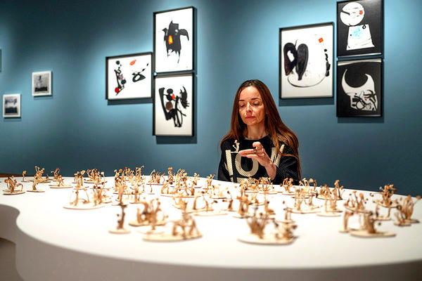 Bettina von Zwehl in Gallery 8 setting up her Ashmolean Now exhibition, The Flood, looking at the Fungi Island display with the Thing Series photos behind
