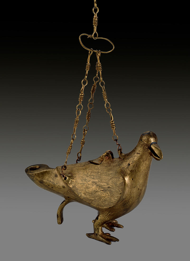 A gold lamp in the form of a dove