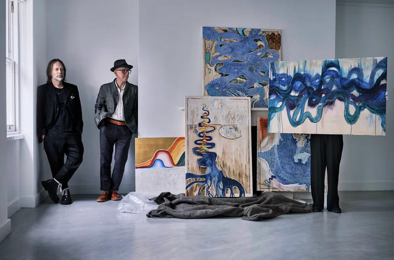 Radiohead's Thom Yorke and co-artist Stanley Donwood with some of their artworks