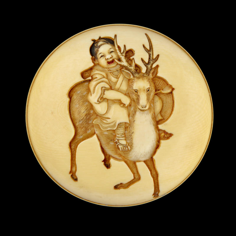 Manjū netsuke depicting a child riding a sacred deer, mid-late 19th century by Meikeisai Hōjitsu