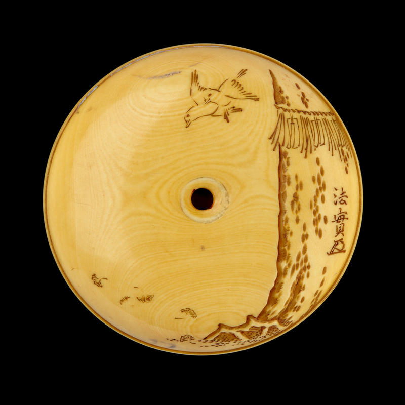 Reverse of a Manjū netsuke depicting a child riding a sacred deer, mid-late 19th century by Meikeisai Hōjitsu
