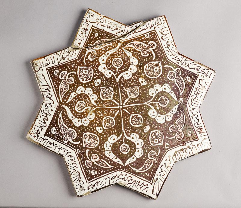 Star tile with vegetal and calligraphic decoration
