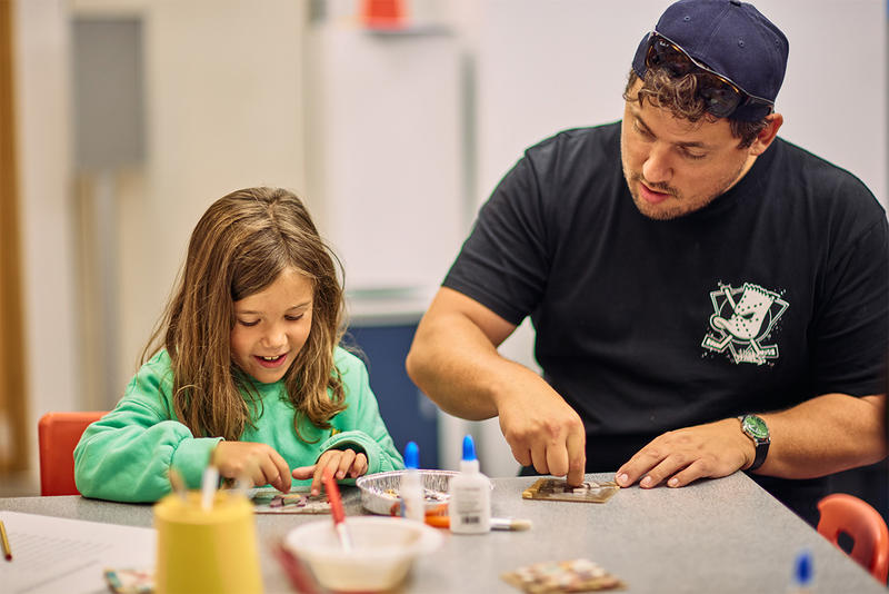 Girl and dad doing craft activities in the Museum