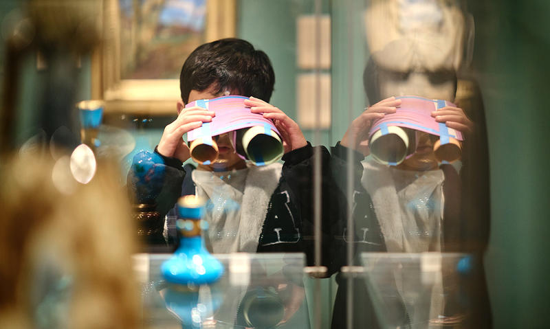 Kids with their own binocular creations looking at objects in the Museum