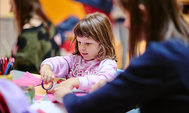 Girl and mother doing craft activities at the family workshop