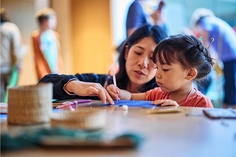 Mum and child doing crafts at the Festival of Archaeology 2025