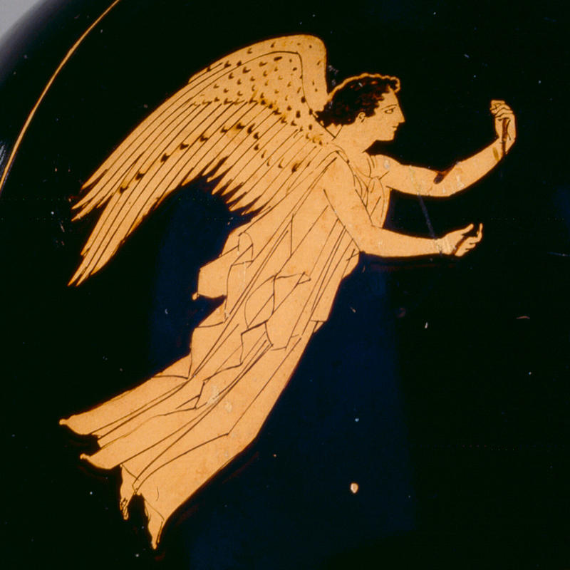 Detail of an ancient Greek black jug with a winged figure in orange