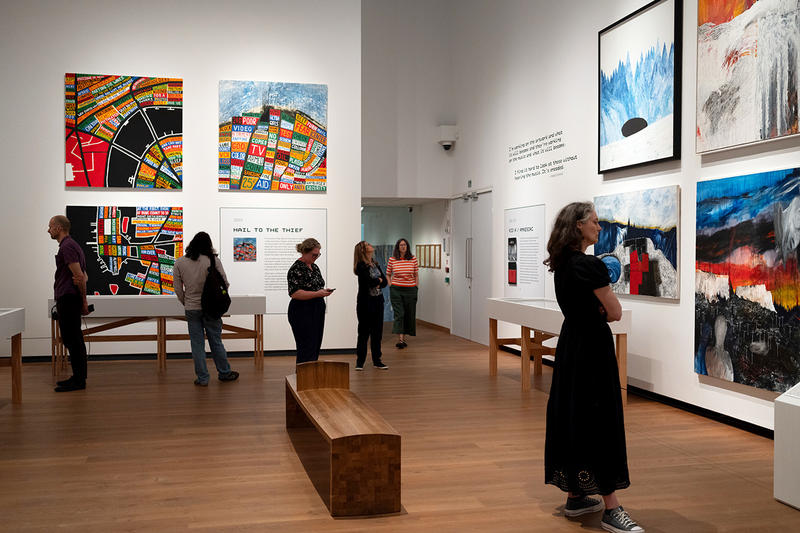 Inside gallery 2 of the This is What you get exhibition with visitors Inside gallery 2 of the This is What you get exhibition with visitors looking at the big colourful artworks
