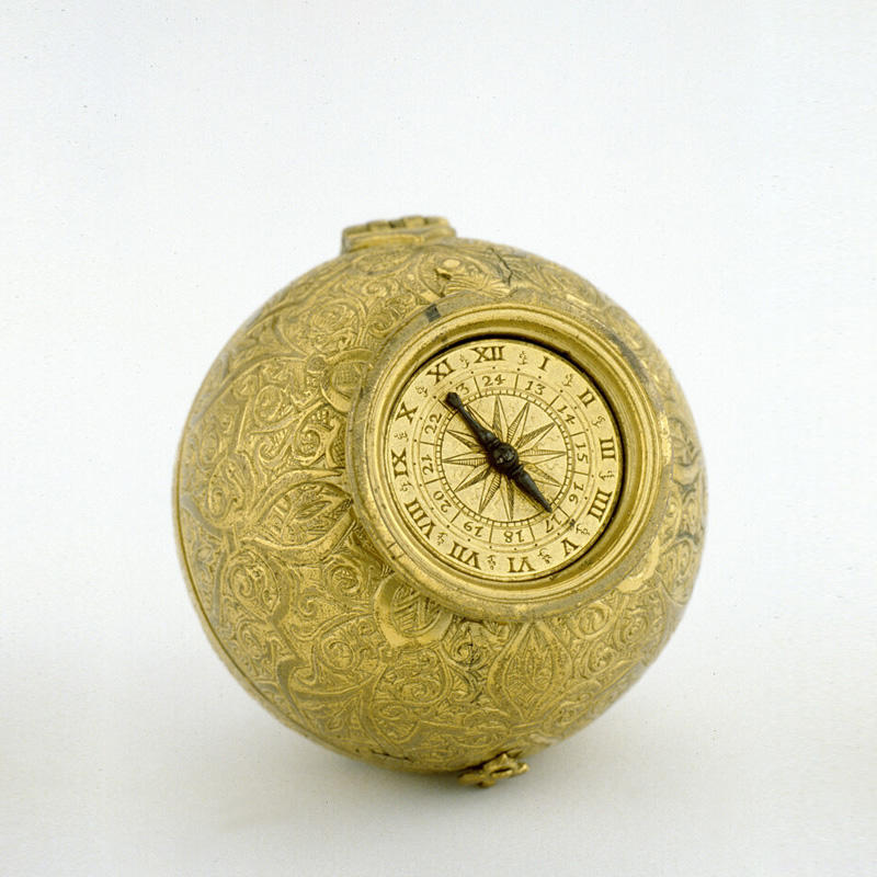 An ornate golden, metallic, spherical ball with a clock face on the front