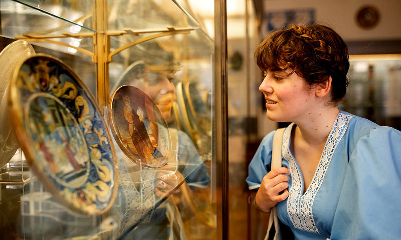 Woman looking at ceramic plates in the galleries