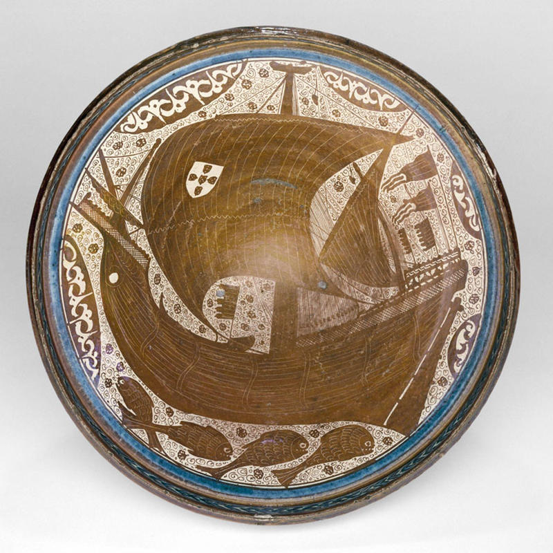 Bowl with Portuguese galleon, Malaga, c. 1425-50, earthenware under an opaque white glaze, with colour in and lustre over the glaze, diam. 51.2 cm. Victoria and Albert Museum, London, acc. no. 486-1864 © Victoria and Albert Museum