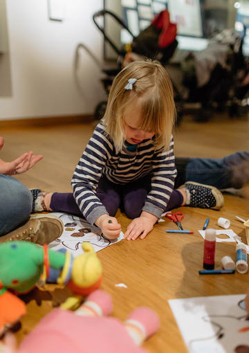 Young child playing with craft activities 