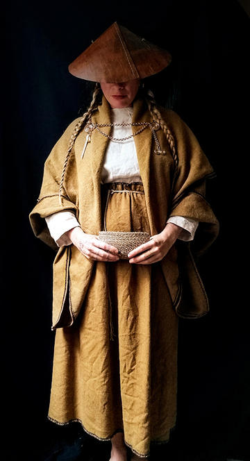 Author Nicole deRushie wearing an example of 'Bog' prehistoric fashion with a hat and sacklike clothes