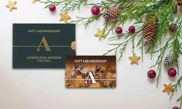 Ashmolean Gift Membership Card and Gift Pack An Ashmolean Museum membership card next to a decorative gift case and festive foliage