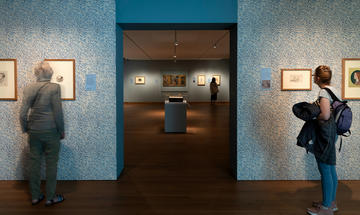 Visitors inside the Pre-Raphaelites exhibition