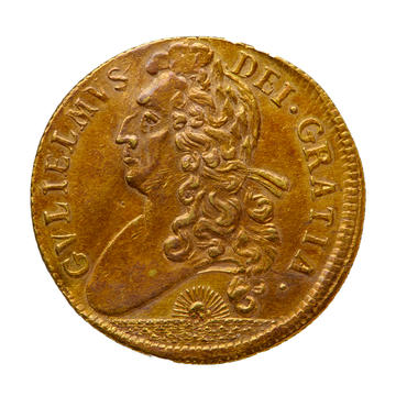 A gold coin engraved with the head of William III from 1701