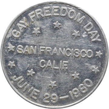 Reverse of a Bulldog Bath token, 1980 - HCR115359 The reverse of an aluminium token 'Gay Freedom Day June 29 1980' is written around the coin and across the middle is written 'San Francisco, Calif.'.