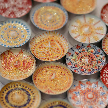 Tea lights painted with colourful patterns
