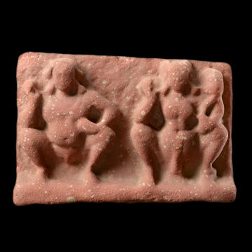 Red sandstone relief plaque with three figures
