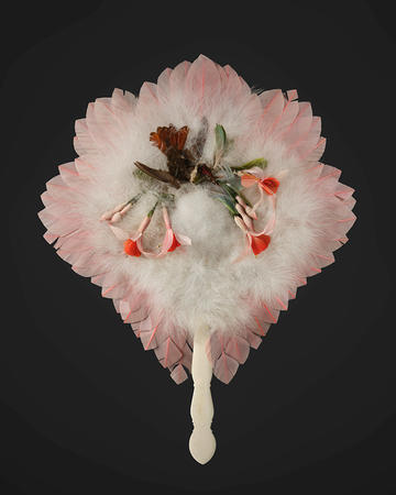 A light pink and white fan made from feathers, card and decorated with a hummingbird.